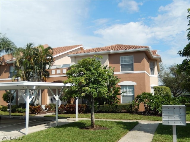 mediterranean / spanish-style home with a front lawn