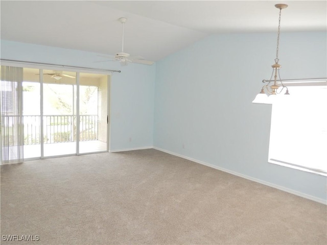 spare room with ceiling fan, vaulted ceiling, and light carpet