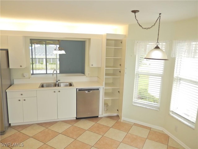 kitchen featuring stainless steel appliances, sink, white cabinetry, light tile patterned flooring, and pendant lighting