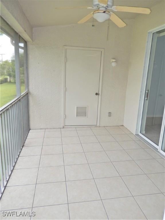 unfurnished sunroom featuring ceiling fan