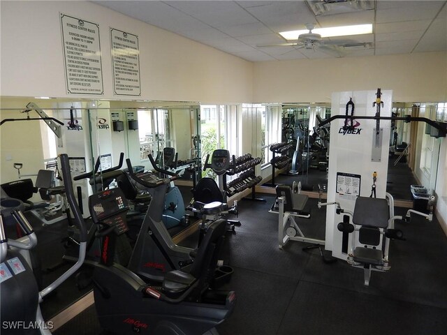 exercise room with a drop ceiling and a ceiling fan