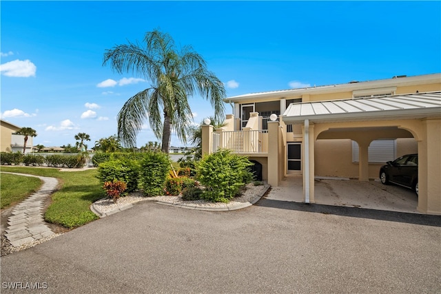 exterior space featuring a lawn and a carport