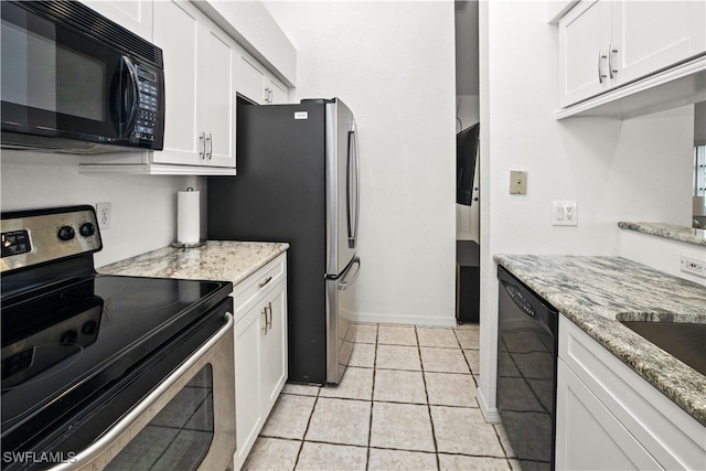 kitchen with black appliances, light tile patterned flooring, light stone countertops, and white cabinets