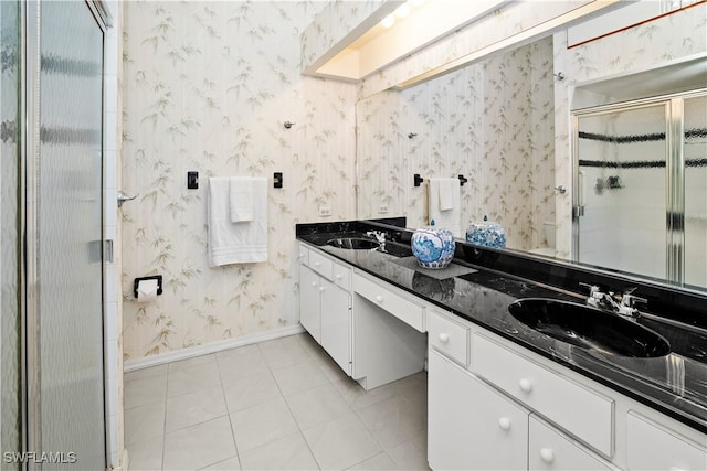 bathroom featuring tile patterned flooring, walk in shower, and vanity