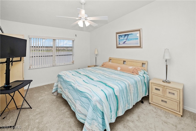 carpeted bedroom with ceiling fan and vaulted ceiling