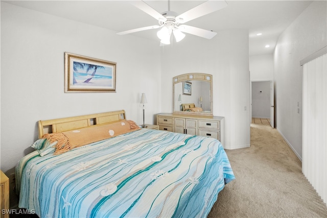 bedroom featuring ceiling fan and light carpet