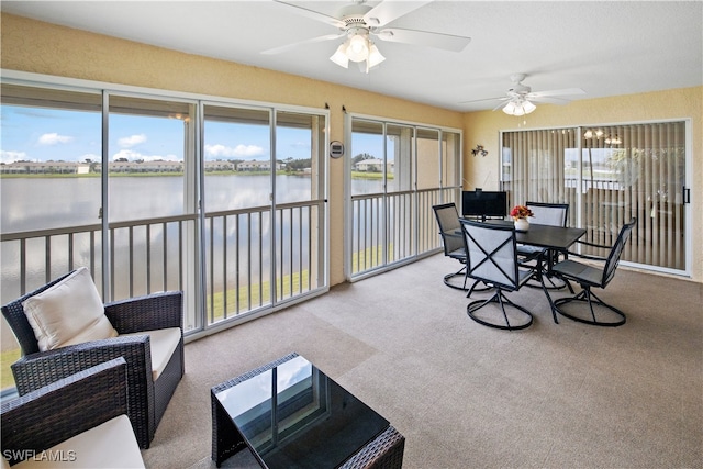 sunroom featuring a healthy amount of sunlight and ceiling fan