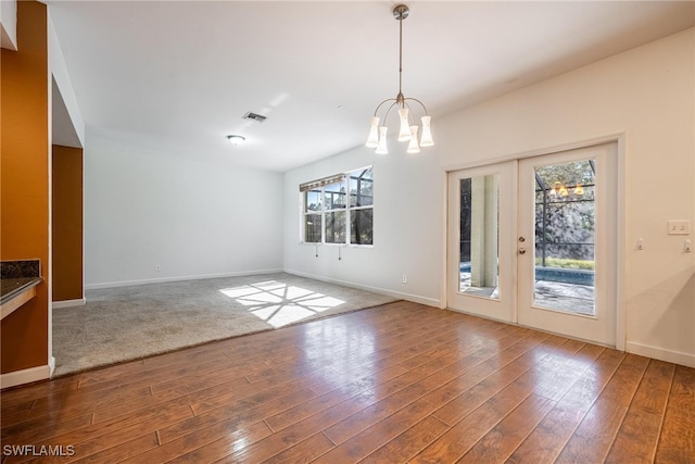 interior space featuring french doors, an inviting chandelier, and hardwood / wood-style flooring