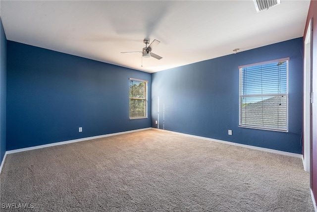 carpeted empty room featuring ceiling fan