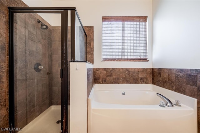 bathroom with separate shower and tub