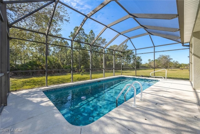 view of pool featuring a lawn, a patio area, and a lanai