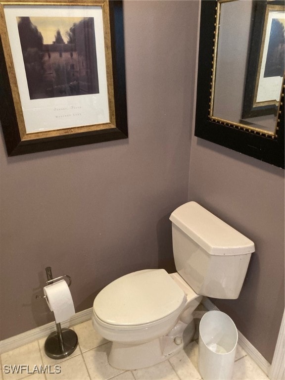 bathroom featuring toilet and tile patterned flooring