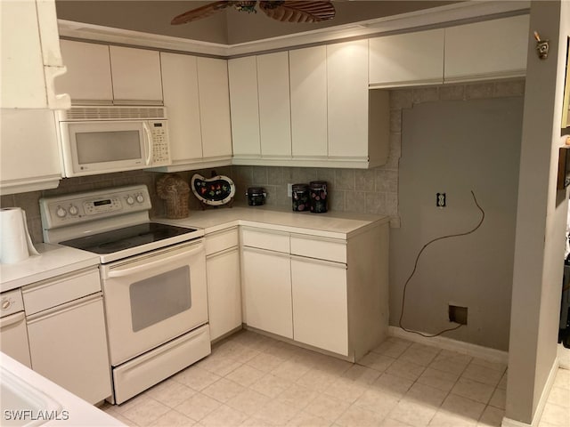 kitchen featuring white appliances, decorative backsplash, white cabinetry, and ceiling fan