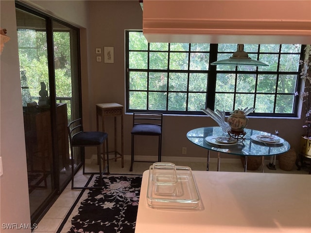 dining area with a healthy amount of sunlight and tile patterned floors