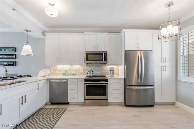 kitchen with stainless steel appliances, white cabinets, and a wealth of natural light