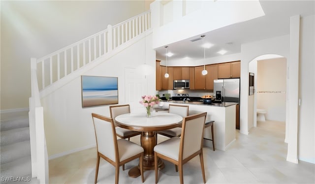 dining area with a towering ceiling