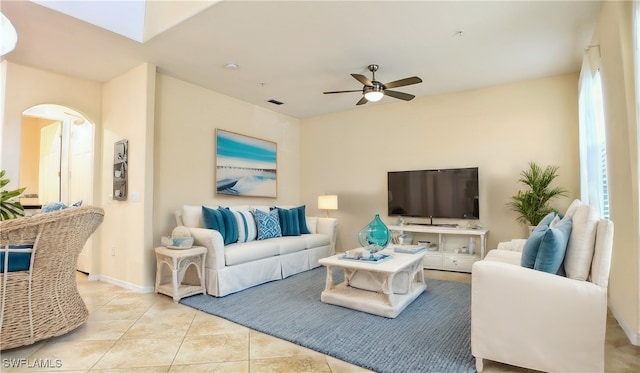 living room with ceiling fan and light tile patterned flooring