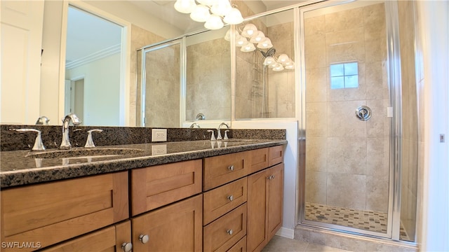 bathroom featuring tile patterned floors, a shower with door, ornamental molding, and vanity