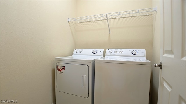 laundry area with washing machine and dryer