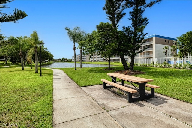 surrounding community featuring a water view and a yard