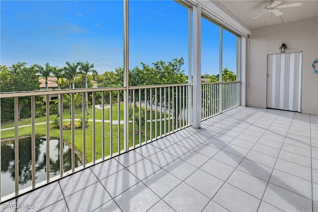 unfurnished sunroom featuring ceiling fan