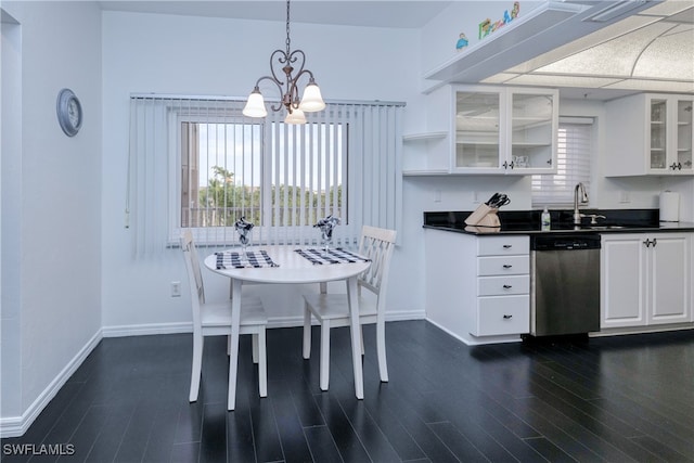 kitchen with white cabinetry, dark hardwood / wood-style flooring, decorative light fixtures, stainless steel dishwasher, and a notable chandelier