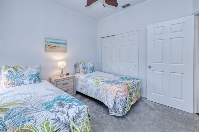 carpeted bedroom featuring ceiling fan and a closet