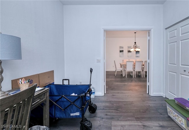 interior space featuring dark wood-type flooring and a notable chandelier