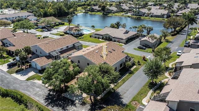 bird's eye view with a water view and a residential view