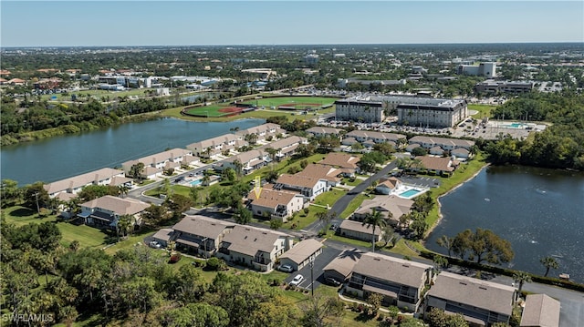 birds eye view of property with a water view and a residential view