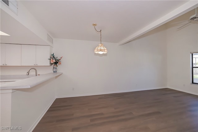 unfurnished dining area with baseboards, beam ceiling, visible vents, and dark wood-style flooring