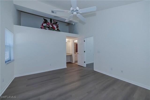 unfurnished room featuring high vaulted ceiling, a ceiling fan, visible vents, and dark wood-style flooring