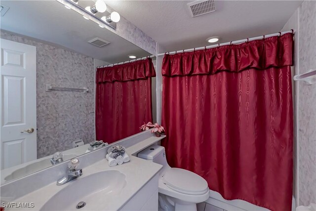 full bathroom featuring toilet, vanity, visible vents, and a shower with curtain