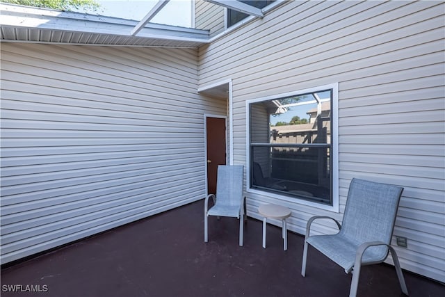 view of patio / terrace featuring glass enclosure