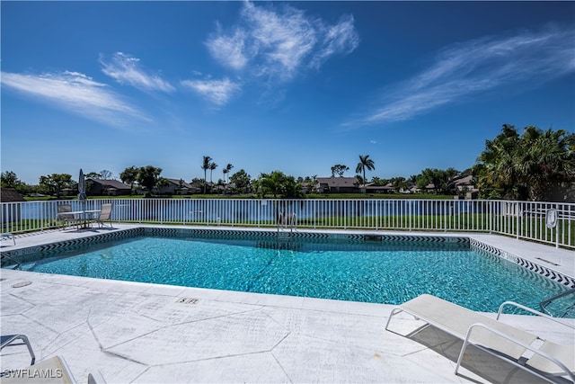 view of pool featuring a patio area, fence, and a fenced in pool