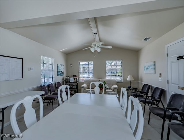 dining area featuring a wealth of natural light, visible vents, lofted ceiling with beams, and light tile patterned floors