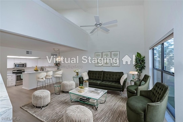 living room featuring ceiling fan and high vaulted ceiling