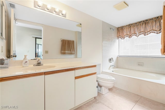 bathroom featuring vanity, tile patterned floors, toilet, and a tub