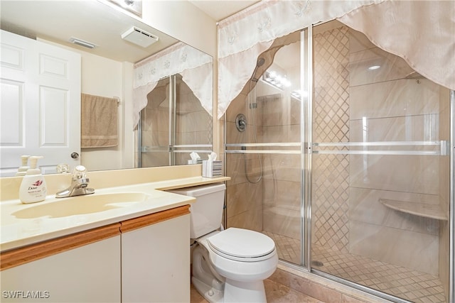 bathroom featuring vanity, a shower with shower door, toilet, and tile patterned flooring