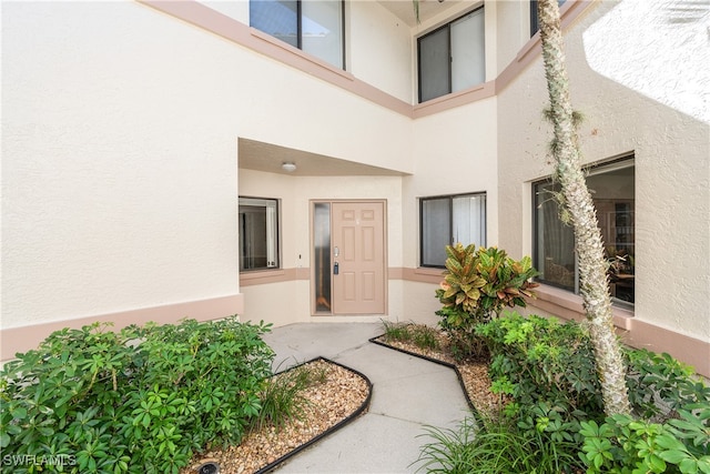 47 Bennington Dr Unit 8-6, Naples, FL 34104 - view of exterior entry with stucco siding
