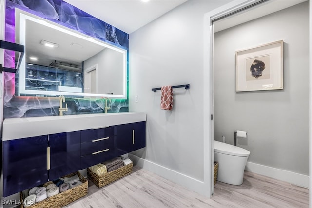 bathroom featuring vanity, hardwood / wood-style floors, and toilet