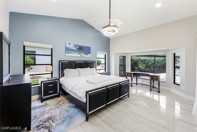 bedroom featuring multiple windows, lofted ceiling, and light hardwood / wood-style floors