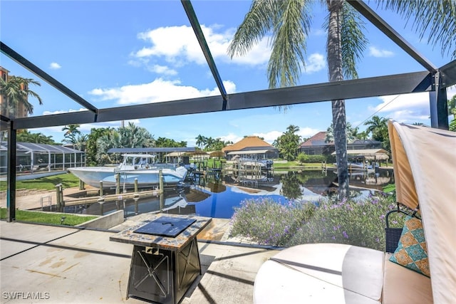 view of patio featuring a lanai, a water view, and a dock