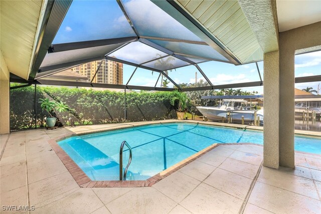 view of swimming pool with a lanai and a patio