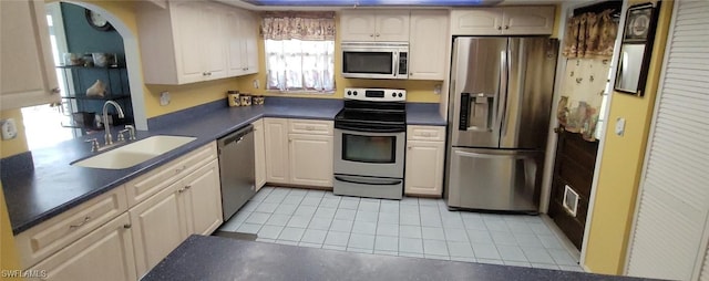 kitchen with light tile patterned floors, sink, and appliances with stainless steel finishes