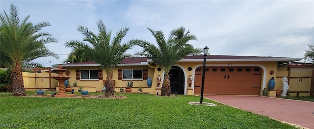 view of front facade with a front yard and a garage