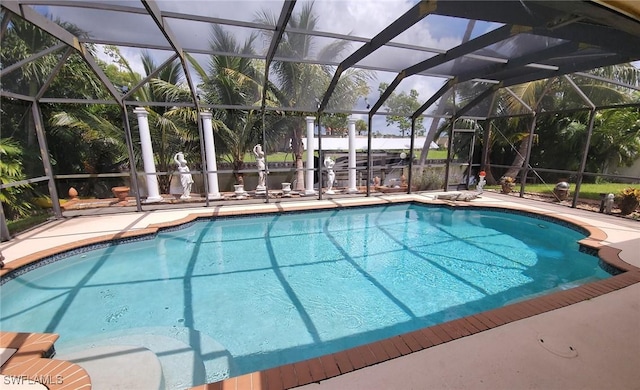 view of pool featuring glass enclosure