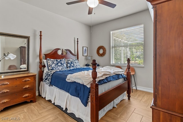 bedroom with ceiling fan and light parquet floors