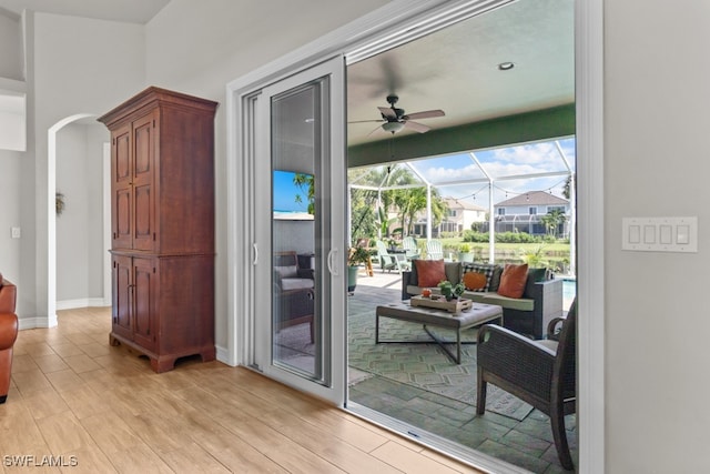 doorway to outside with ceiling fan and light hardwood / wood-style floors