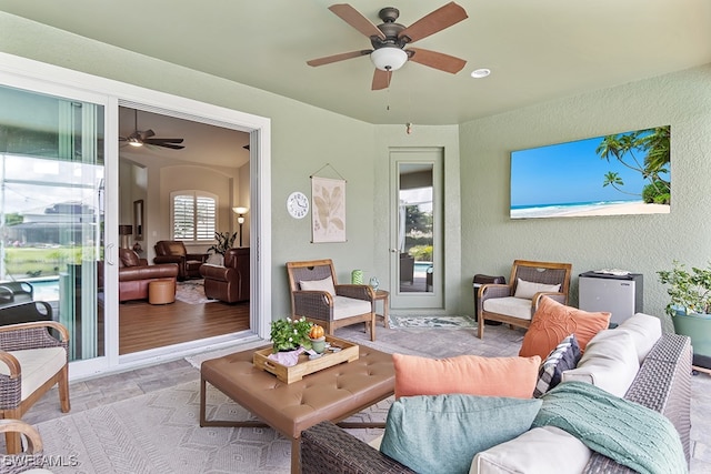 living room with light hardwood / wood-style flooring and ceiling fan